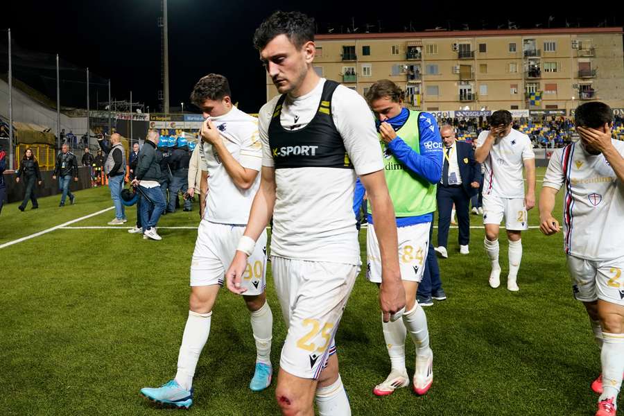 Sampdoria players walk off the field after having suffered relegation to Serie C.