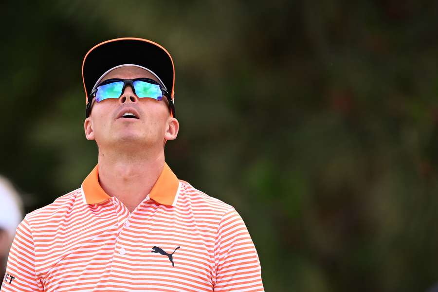 Rickie Fowler of the United States reacts to his tee shot on the 11th tee 