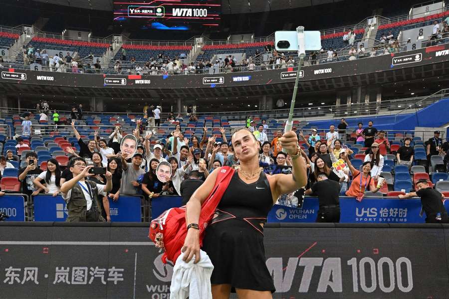 Sabalenka takes a picture after her win