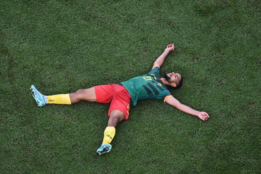 Jean-Charles Castelletto lies on the pitch at the end of the Qatar 2022 World Cup Group G football match between Cameroon and Serbia