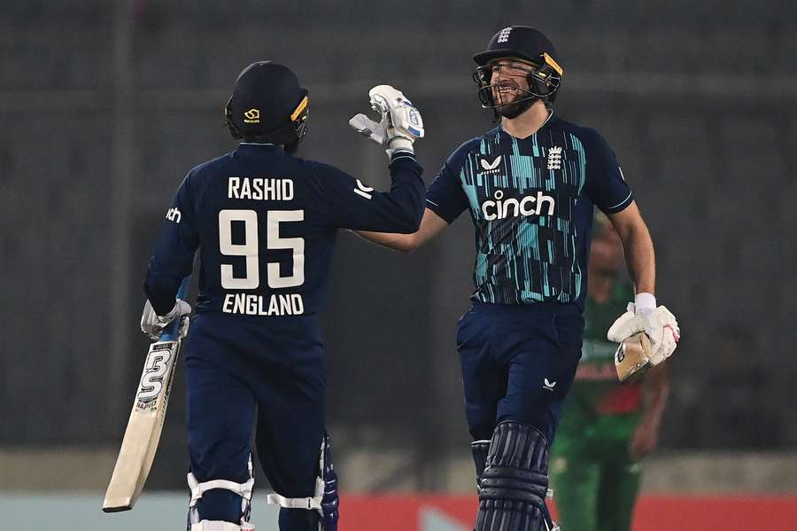 England's Adil Rashid and Dawid Malan celebrate their win at the end of the first one-day international