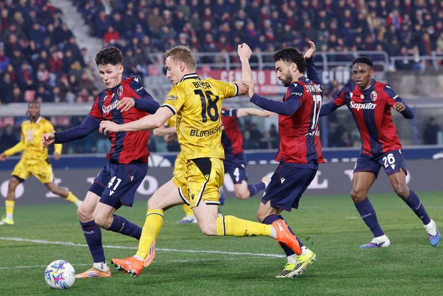 Bologna's Martin Vitik and Joao Mario in action with Udinese's Adam Buksa