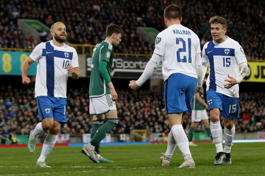 Finland's striker Benjamin Kallman celebrates with teammates after scoring the opening goal