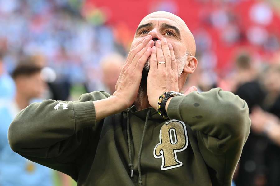 Manchester City's Spanish manager Pep Guardiola celebrates on the pitch after the English FA Cup final 