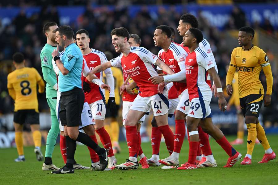 Arsenal players react after Myles Lewis-Skelly was shown a red card at Wolves