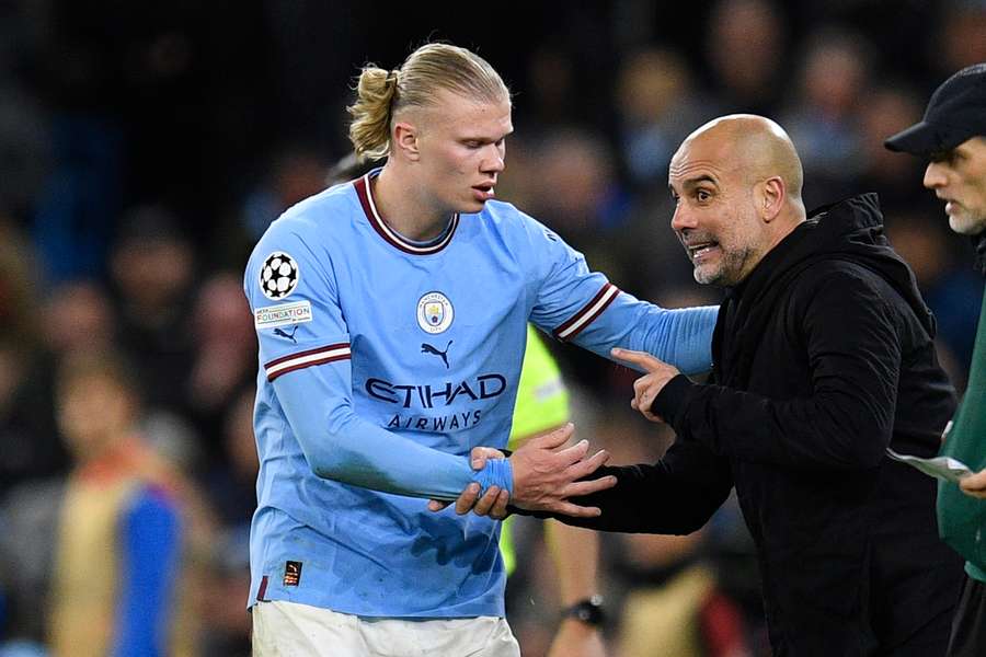 Erling Haaland receives instructions from manager Pep Guardiola during the game against Bayern