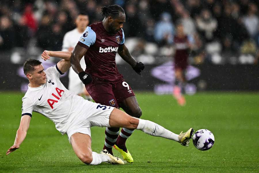 Tottenham Hotspur's Micky van de Ven (L) tackles West Ham United's Michail Antonio