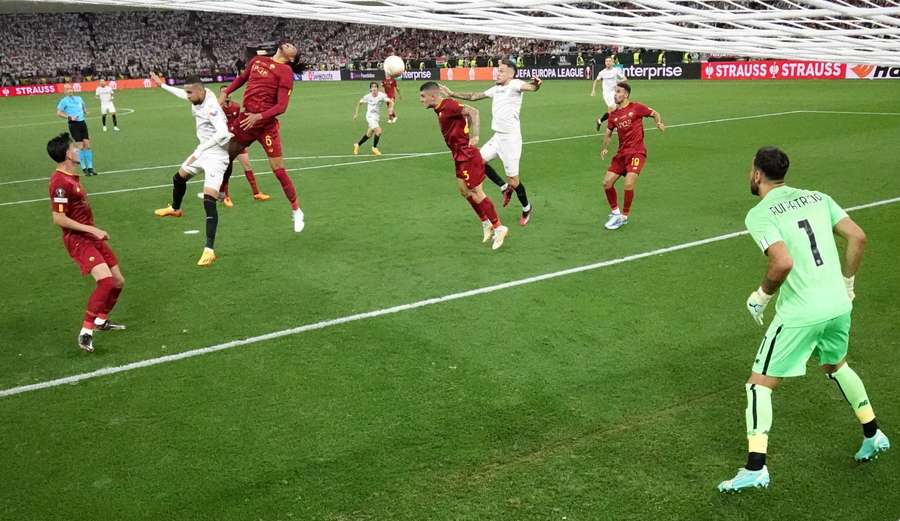 Sevilla's Lucas Ocampos and Roma's Gianluca Mancini vie for the ball