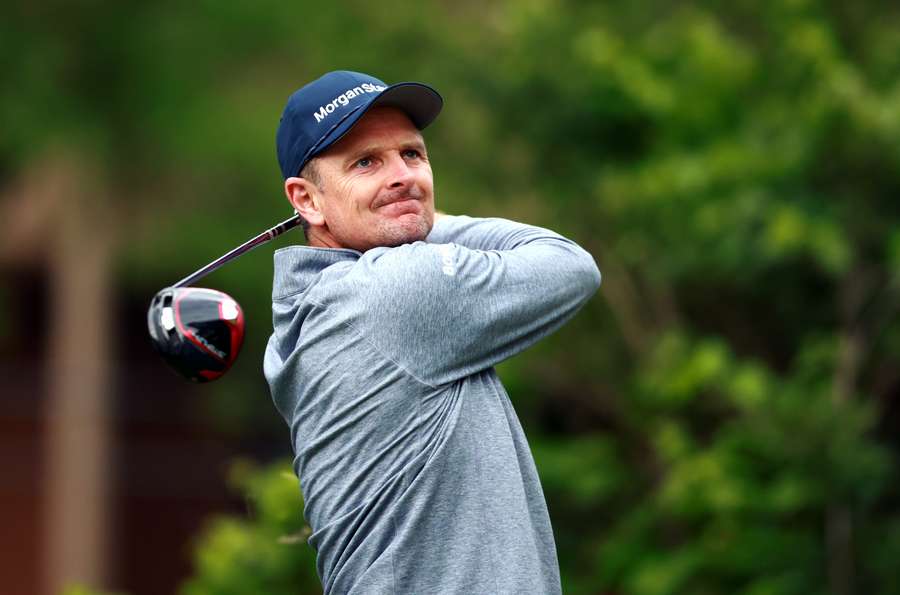 Justin Rose of England hits his first shot