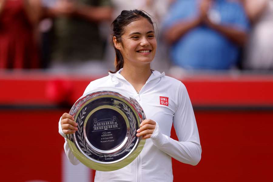 Britain's Emma Raducanu celebrates with the runners-up trophy after losing her final match against Croatia's Donna Vekic