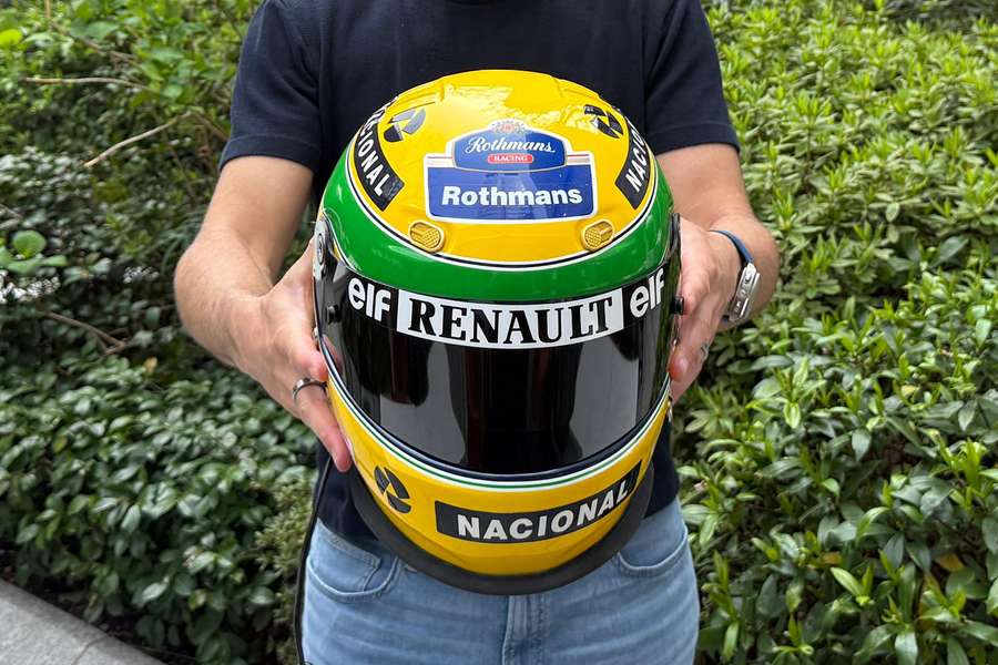 Darren Jack, a Canadian motorsports memorabilia collector from Toronto, poses with the racing helmet