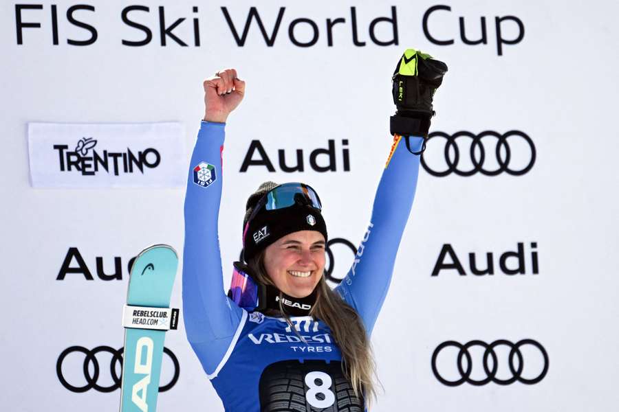 Italy's Laura Pirovano celebrates on the podium after winning in Val di Fassa