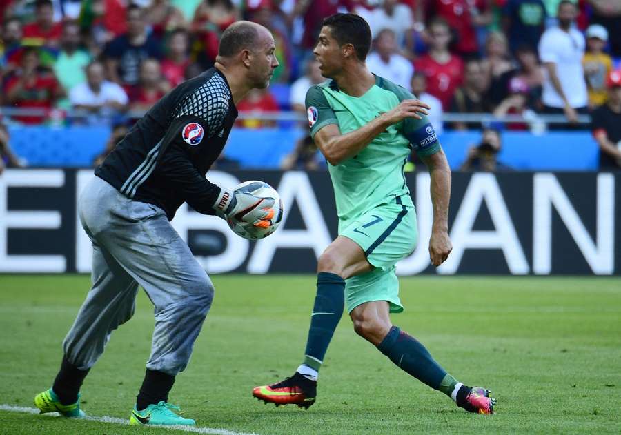 Gábor Király saving the ball before Cristiano Ronaldo.
