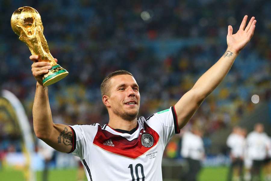 Lukas Podolski lifts the trophy after winning the 2014 World Cup with Germany Lukas Podolski lifts the trophy after winning the 2014 World Cup with Germany