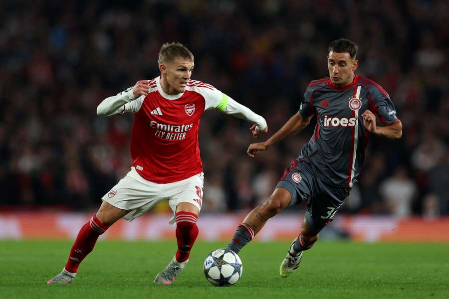 Arsenal midfielder Martin Odegaard runs with the ball