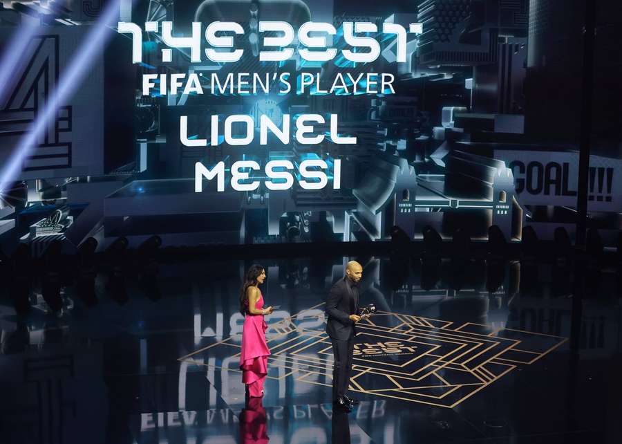Thierry Henry collects the award on Messi's behalf