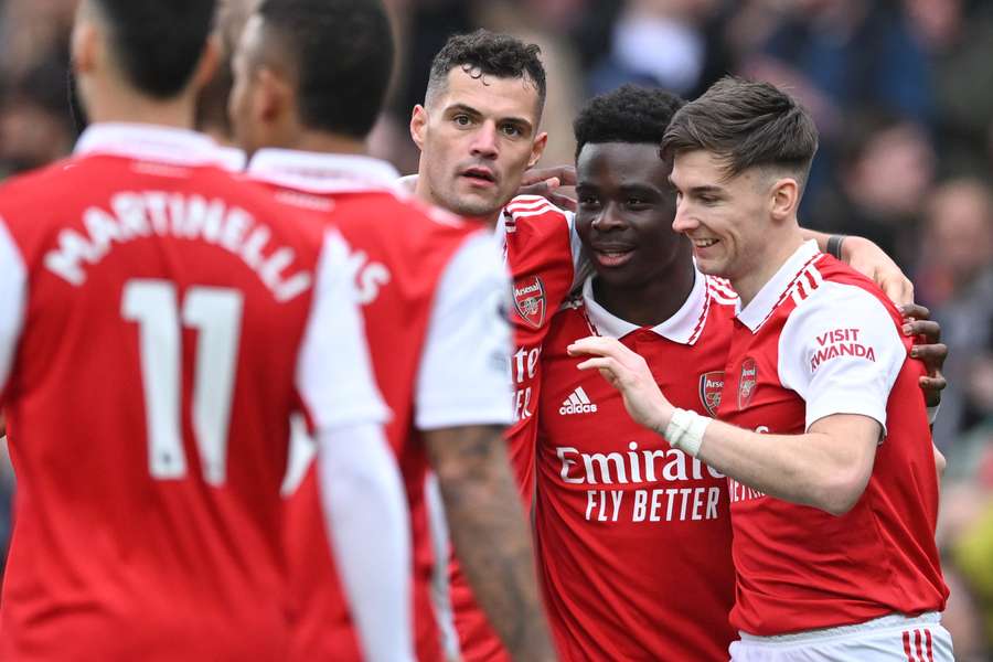 Saka (second from right) celebrates with his Arsenal teammates.