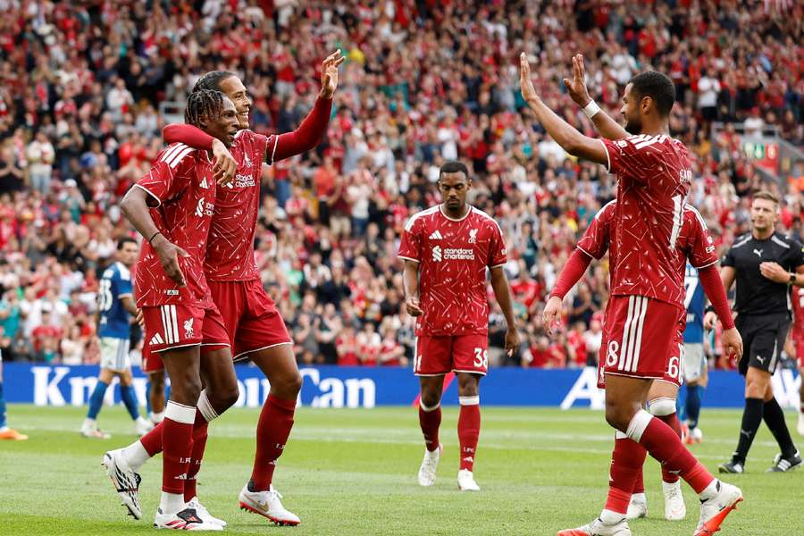 Virgil van Dijk celebrates with teammates Virgil van Dijk celebrates with teammates