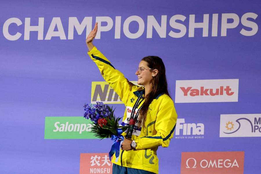 Gold medallist Australia's Kaylee McKeown celebrates on the podium after winning the women's 200m backstroke final