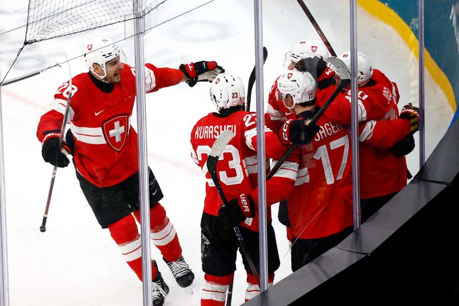 Roman Josi of Switzerland celebrates scoring their first goal with teammates Roman Josi of Switzerland celebrates scoring their first goal with teammates