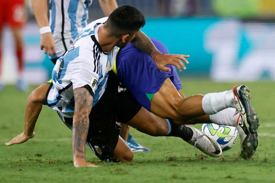 Argentina's Cristian Romero makes a crunching challenge