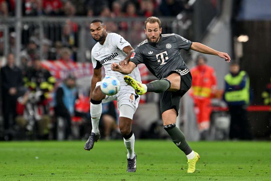 Bayern Munich's Harry Kane gets a shot off against Leverkusen's Jonathan Tah