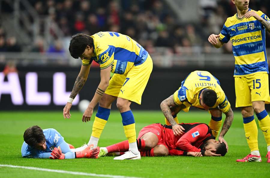 AC Milan's Ruben Loftus-Cheek and Parma's Edoardo Corvi after both sustaining injuries