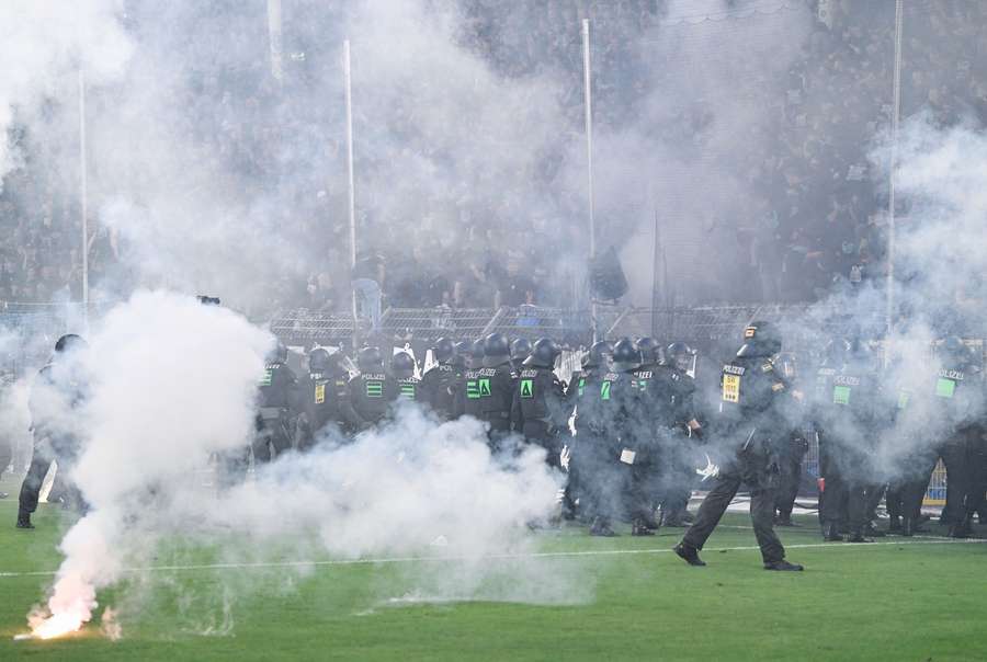 Police officers stand in front of SV Waldhof Mannheim fans Police officers stand in front of SV Waldhof Mannheim fans