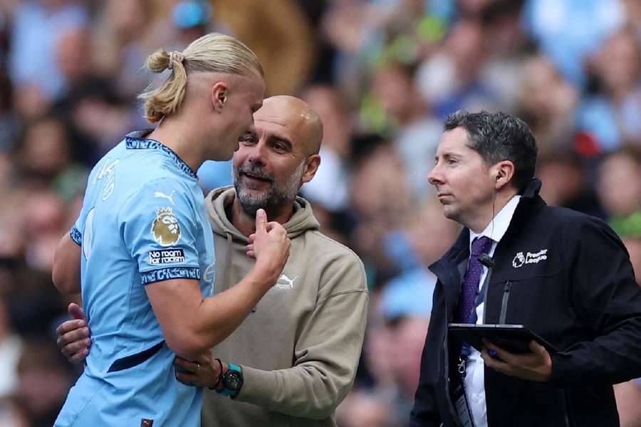 Manchester City manager Pep Guardiola reacts with Erling Haaland after he was substituted