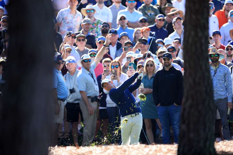 Rory McIlroy of Northern Ireland plays his second shot on the 18th hole during the completion of the weather delayed second round 