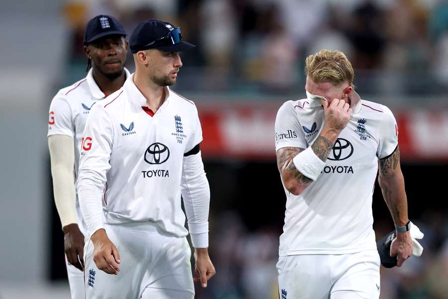 England captain Ben Stokes (R) reacts with teammates as he walks off the ground on day two of the second Ashes Test