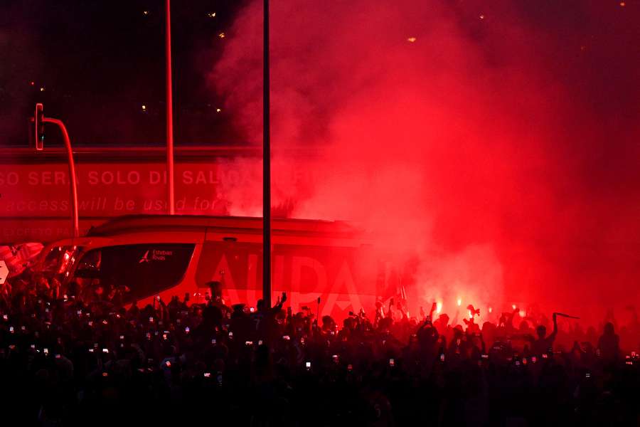 A general view as fans set off red flares outside the stadium 