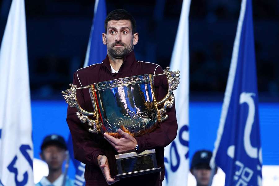 Novak Djokovic reacts with the trophy after winning the final against Alex de Minaur Novak Djokovic reacts with the trophy after winning the final against Alex de Minaur