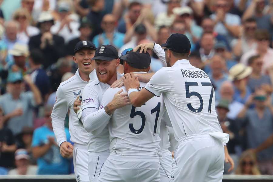 England's captain Ben Stokes (2L) and England players celebrate after Australia's Marnus Labuschagne loses his wicket
