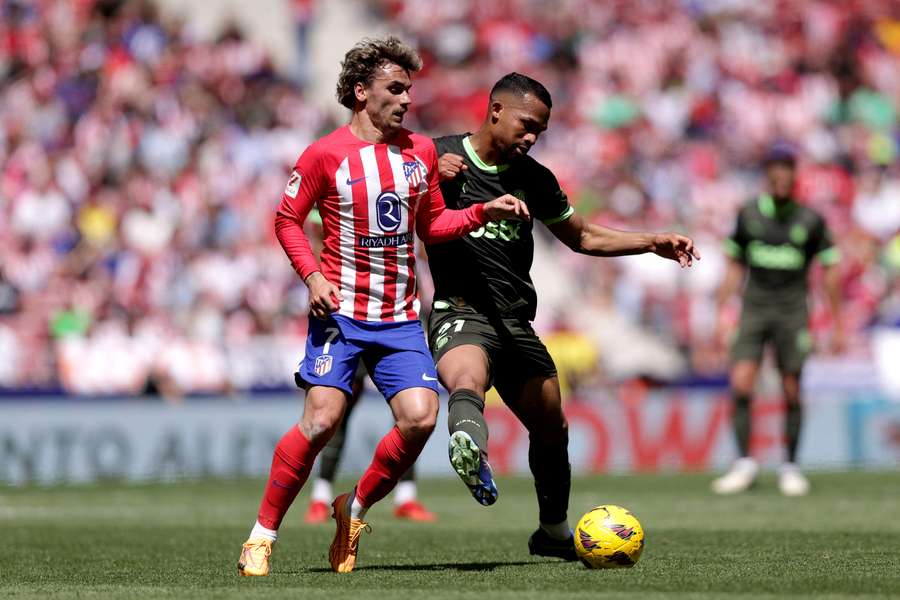 Antoine Griezmann of Atletico Madrid battles for possession with Yangel Herrera of Girona