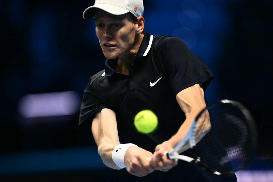 Italy's Jannik Sinner hits a return to Australia's Alex de Minaur during their match at the ATP Finals tennis tournament in Turin