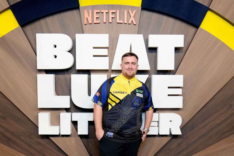 Luke Littler poses in front of a Beat Luke Littler sign Luke Littler poses in front of a Beat Luke Littler sign