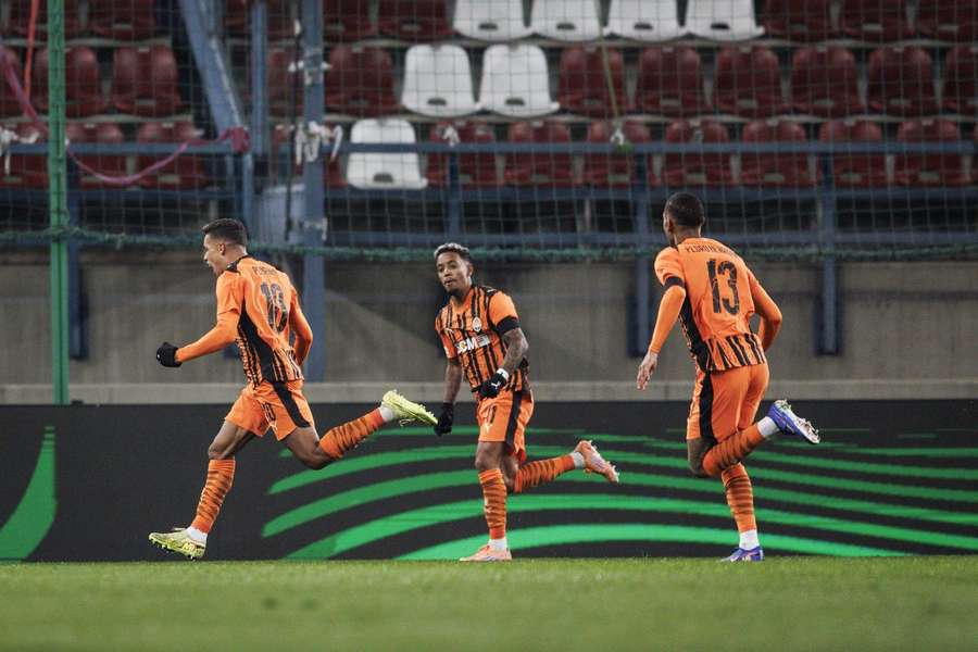 Shakhtar's Pedrinho (L) celebrates scoring the 1-0 against AZ