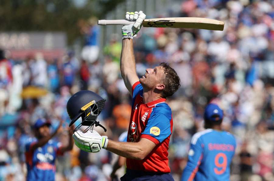 England's Jos Buttler raises his bat and helmet as he walks after losing his wicket