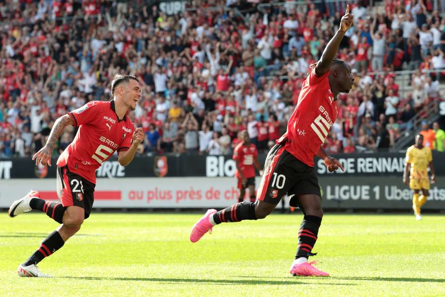 Jeremy Doku (R) peels away in celebration for Rennes