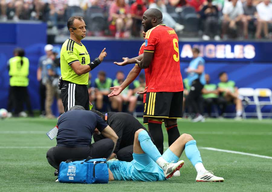 Iran's Alireza Beiranvand receives medical attention after sustaining an injury as Belgium's Romelu Lukaku speaks to referee Dario Herrera Iran's Alireza Beiranvand receives medical attention after sustaining an injury as Belgium's Romelu Lukaku speaks to referee Dario Herrera
