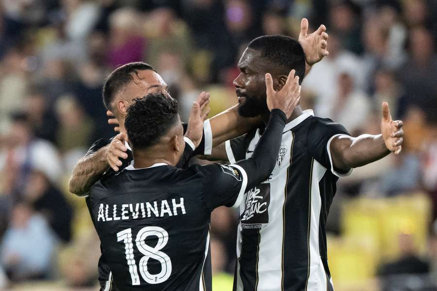 Angers' Ivorian midfielder Jean-Eudes Aholou celebrates with teammates after scoring