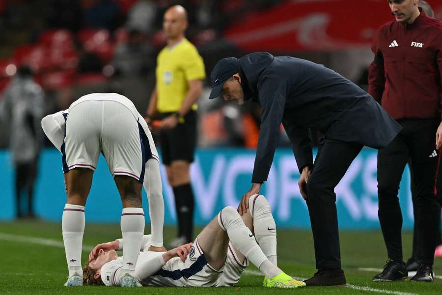 England's German head coach Thomas Tuchel checks on England's Anthony Gordon 