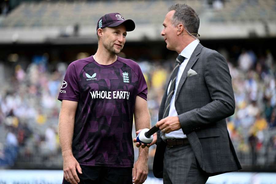 Michael Vaughan chats with England batter Joe Root in his capacity as a TV broadcaster.
