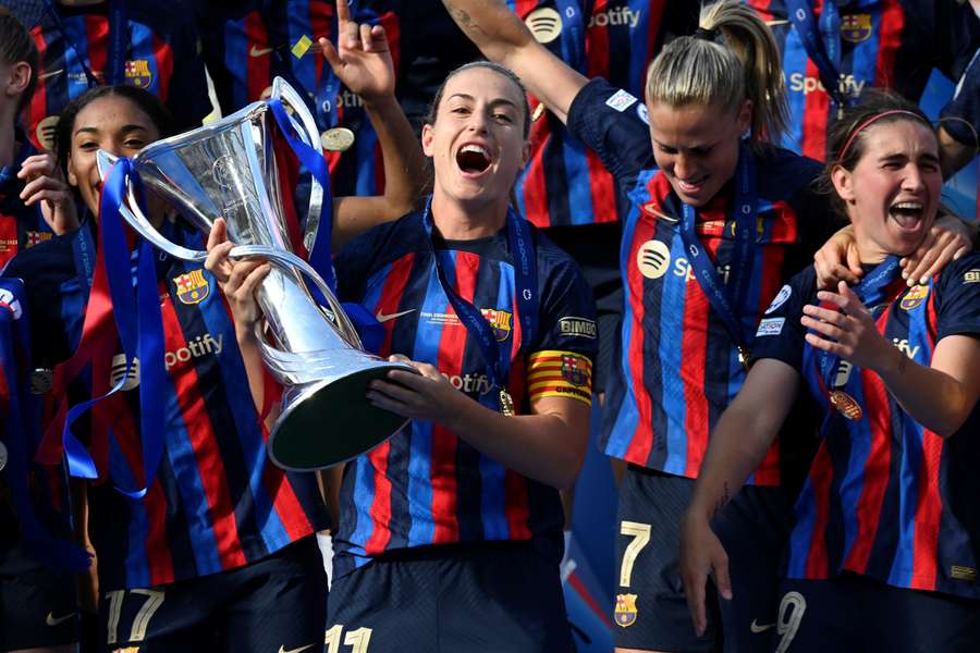Barcelona midfielder Alexia Putellas and her teammates celebrate with the trophy after winning the women's Champions League