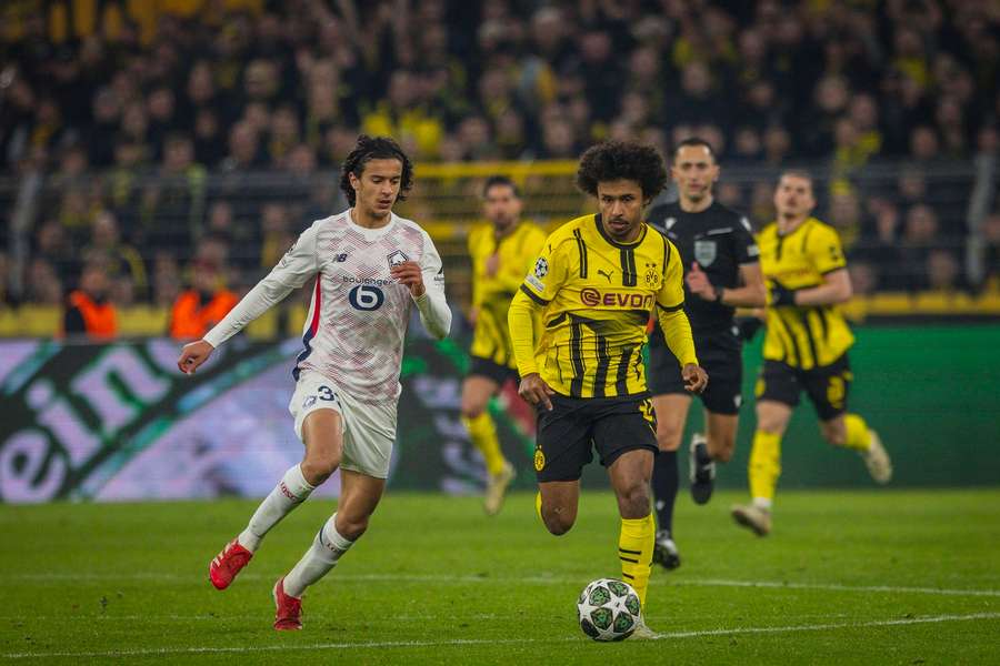 Borussia Dortmund's Karim Adeyemi battles with Lille's Ayyoub Bouaddi during the Champions League Round of 16 first leg tie.