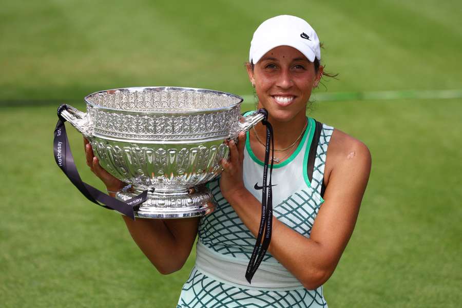 Madison Keys poses with the winner's trophy in Eastbourne