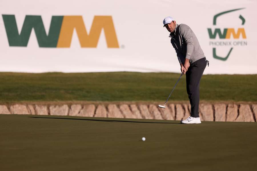 Scottie Scheffler putts on the 17th green