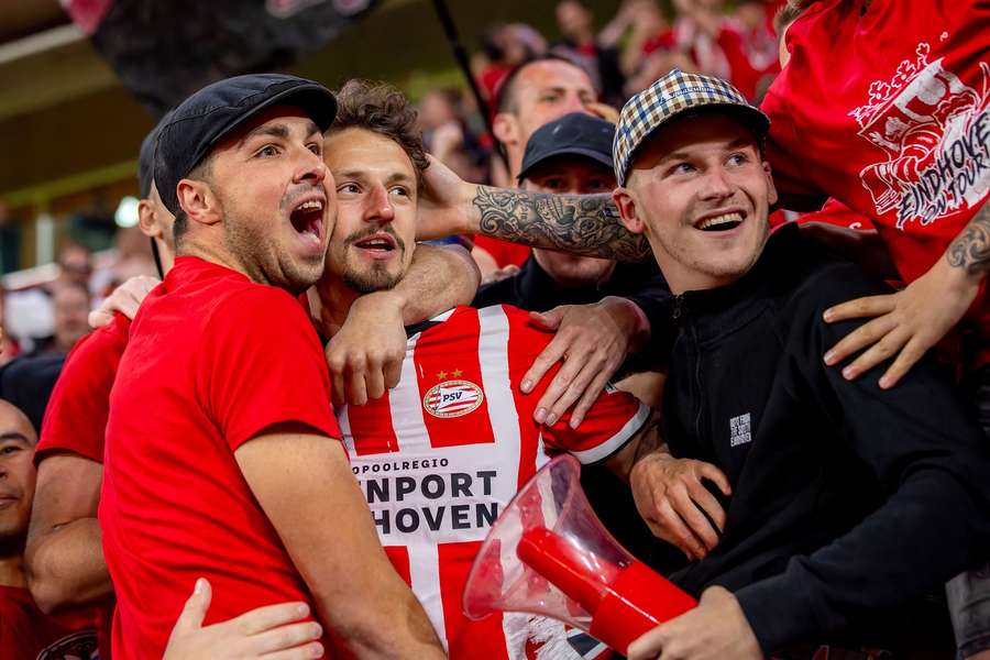 PSV defender Olivier Boscagli celebrates retaking the top spot with fans after the game against Heracles