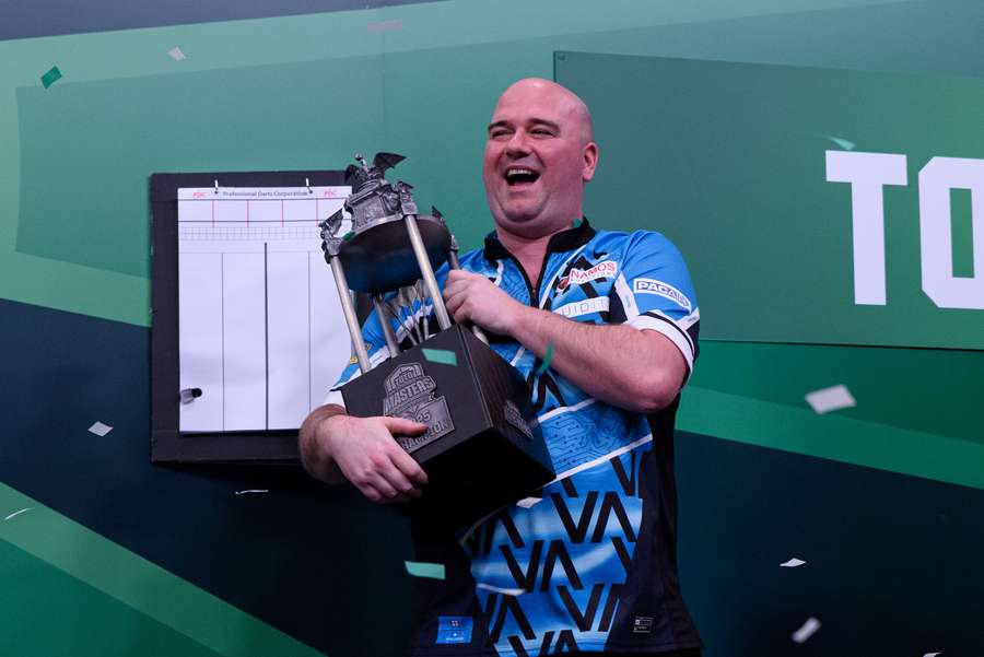 Rob Cross holding the Toon Greebe Trophy after winning the Dutch Darts Masters